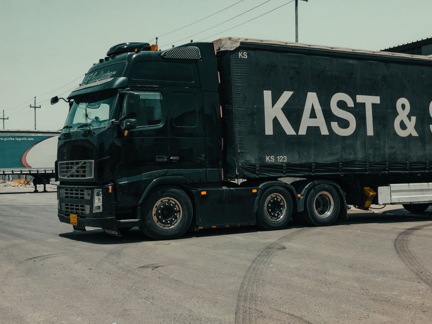 A large industrial truck parked in an urban setting, showcasing transportation industry visuals.